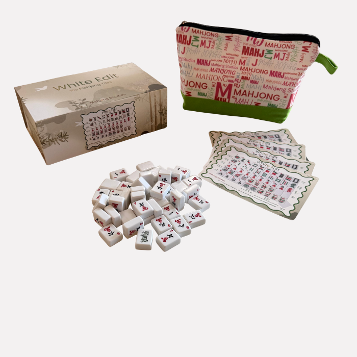 Mahjong set with tiles, packaging, and pouch on a white background